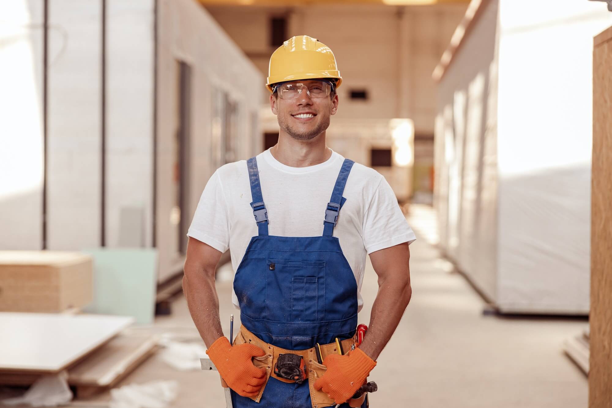 cheerful-male-builder-standing-at-construction-site-1.jpg