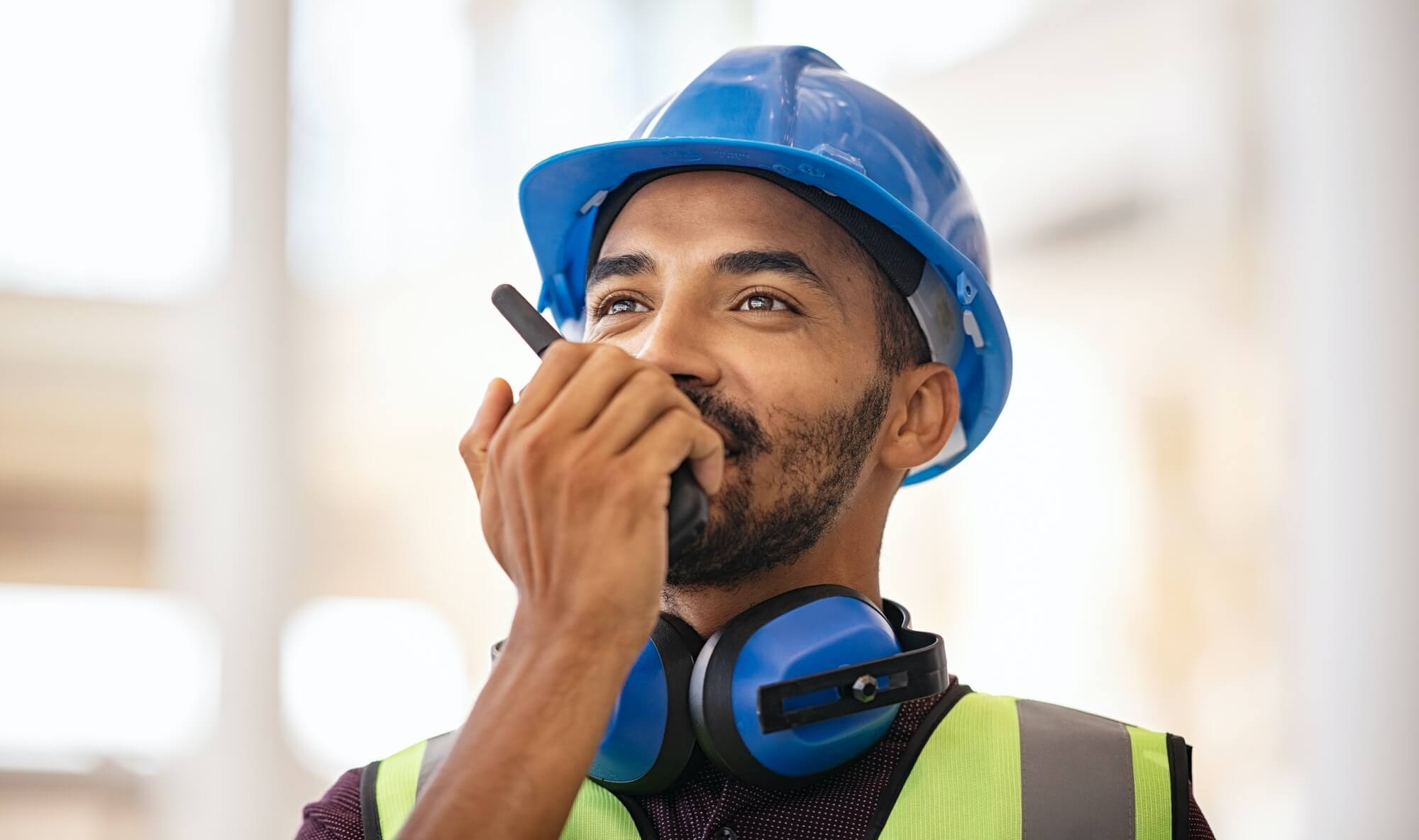 mixed-race-construction-worker-using-walkie-on-construction-site-1.jpg